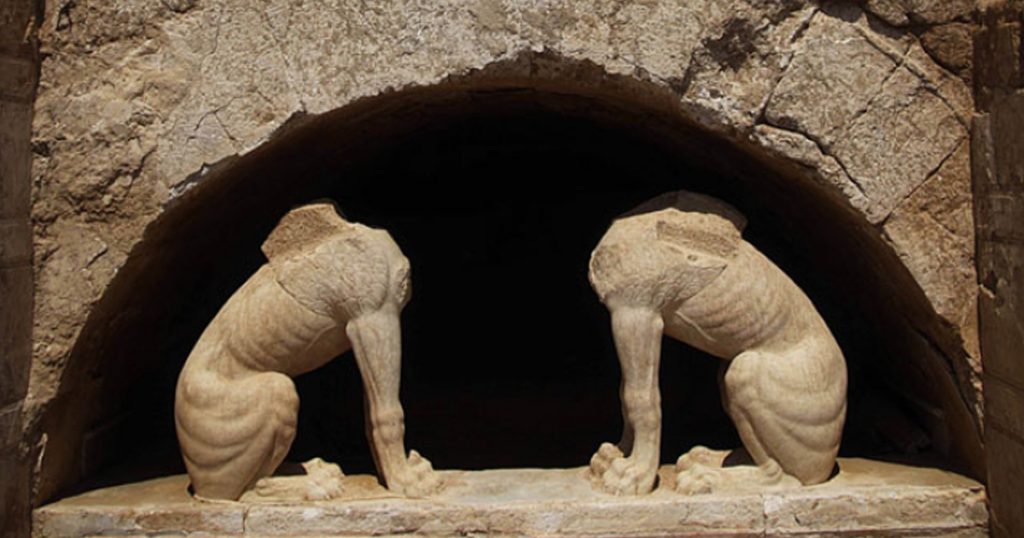 Two headless sphinx statues made of marble, guarding the entrance to the ancient tomb of Amphipolis in northern Greece, partially unearthed during ongoing archaeological excavations.