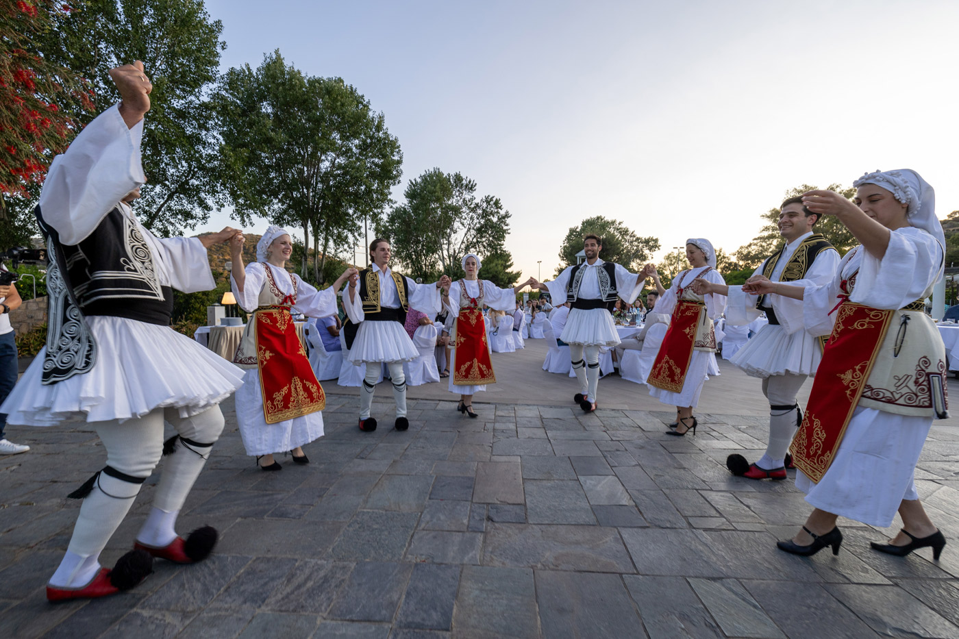 Traditional Greek dancers performing in national costumes during a corporate gala dinner — cultural entertainment organized as part of a team building and incentive event in Greece.
