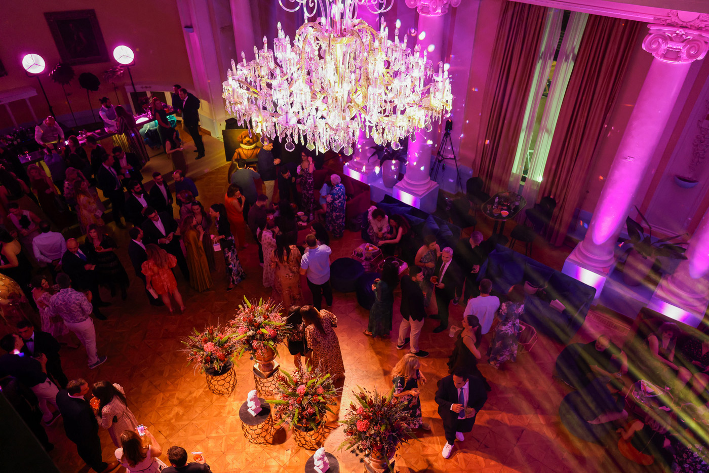 Elegant corporate gala event in Greece — DMC agency organizing incentive evening with guests networking under a grand chandelier.