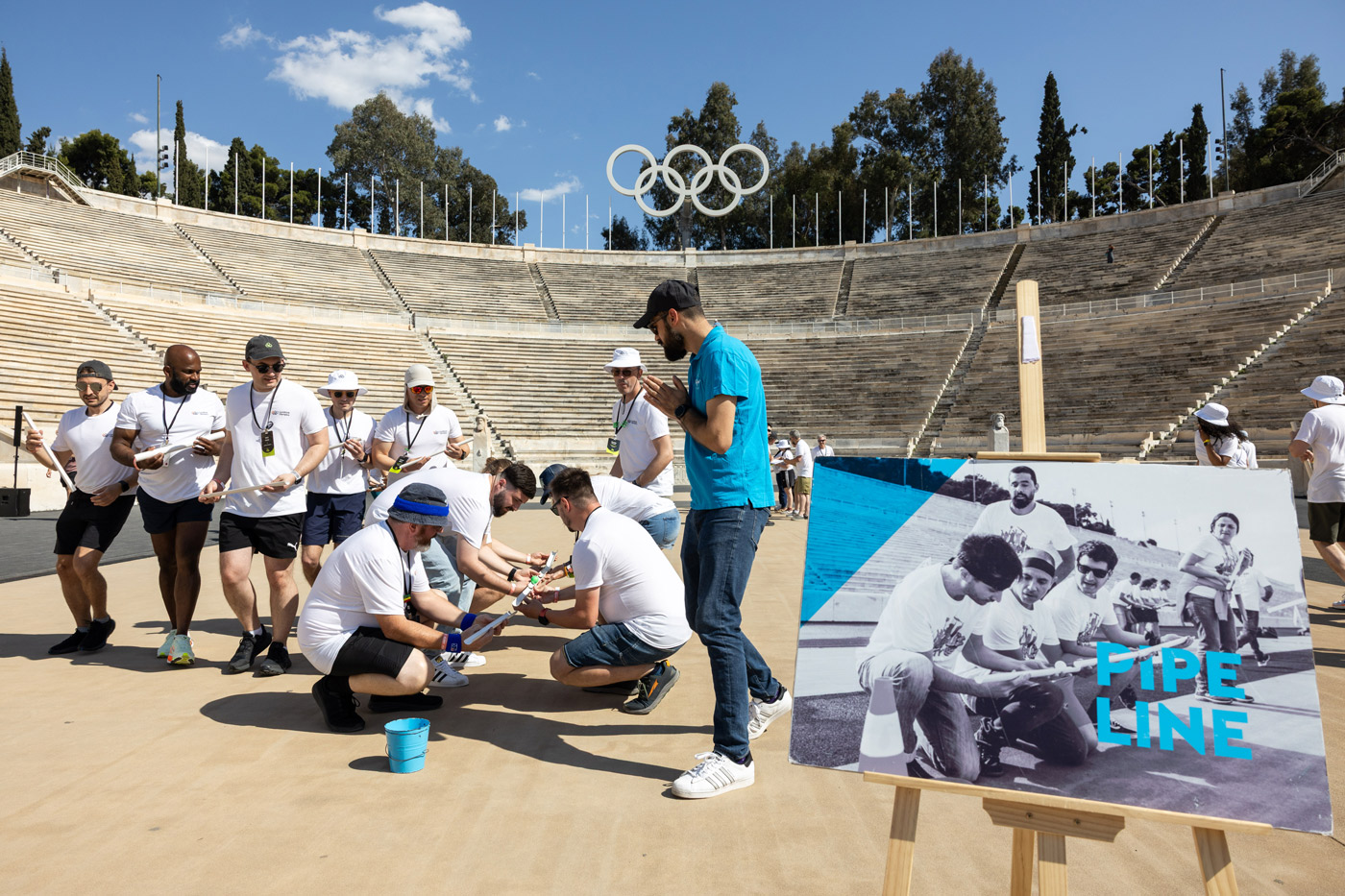 Corporate team building activity at the Panathenaic Stadium in Athens, Greece — group of participants collaborating in an Olympic-themed challenge organized by a DMC agency.