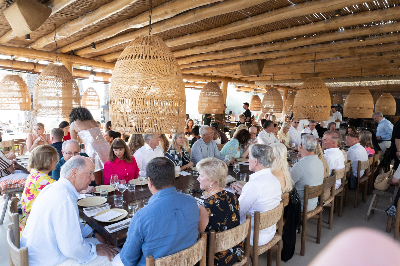 Corporate dinner event in Greece — DMC agency organizing seaside incentive evening with guests enjoying a relaxed team building atmosphere.