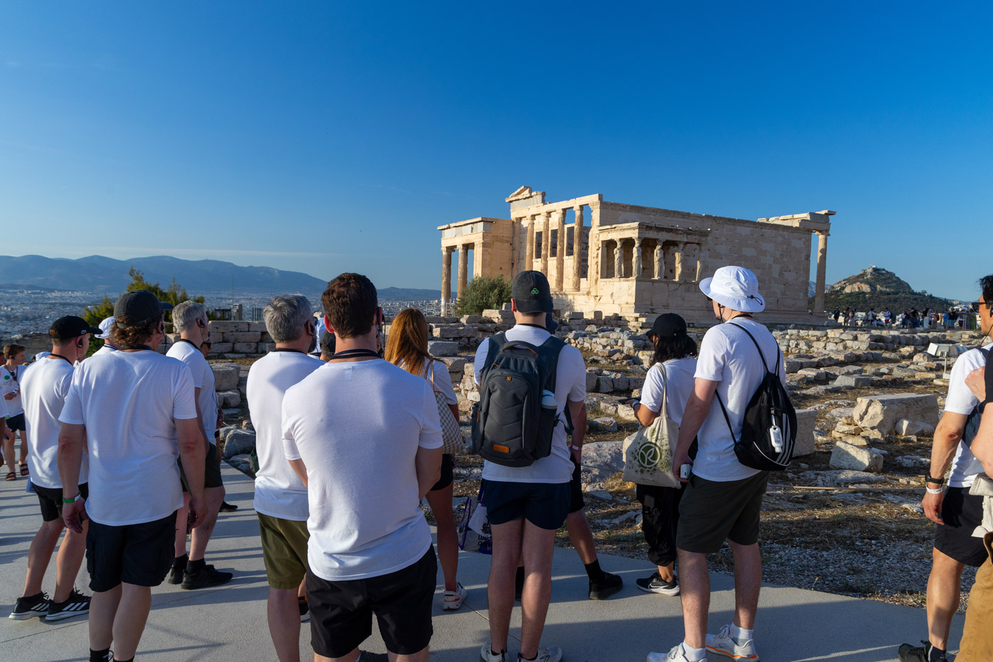 Corporate team building event in Athens, Greece — group of participants visiting the Acropolis and learning about Greek history during a cultural experience organized by a DMC agency.