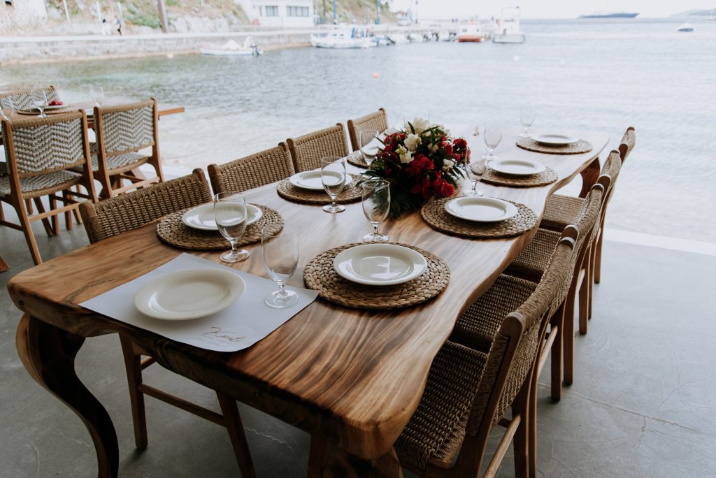 Seaside corporate event setup in Greece — DMC agency organizing incentive dinner and elegant team building experience by the sea.