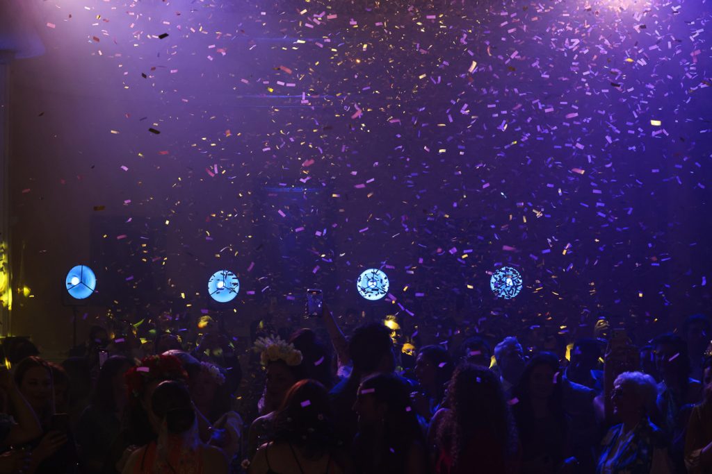 Corporate event celebration in Greece — DMC agency organizing gala night with music, confetti, and fun team building atmosphere.