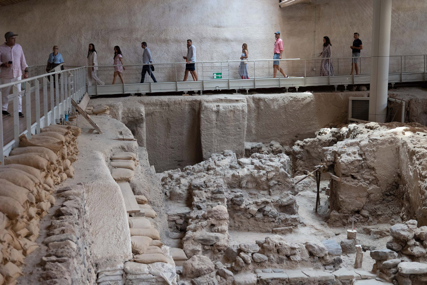 YPO Mayfair incentive trip in Greece – guests exploring the Akrotiri archaeological site in Santorini, curated by DMC agency Feelosophy for cultural team building and corporate travel experiences.
