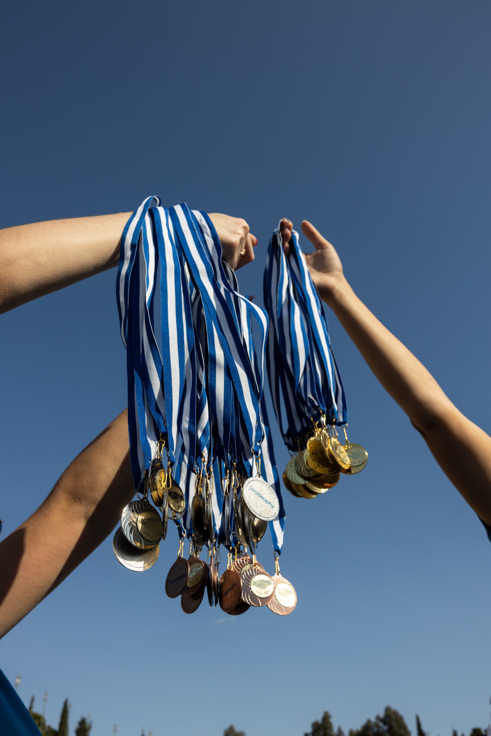 Team building event in Greece — employees celebrating success and achievement with medals during a corporate event organized by a DMC agency.