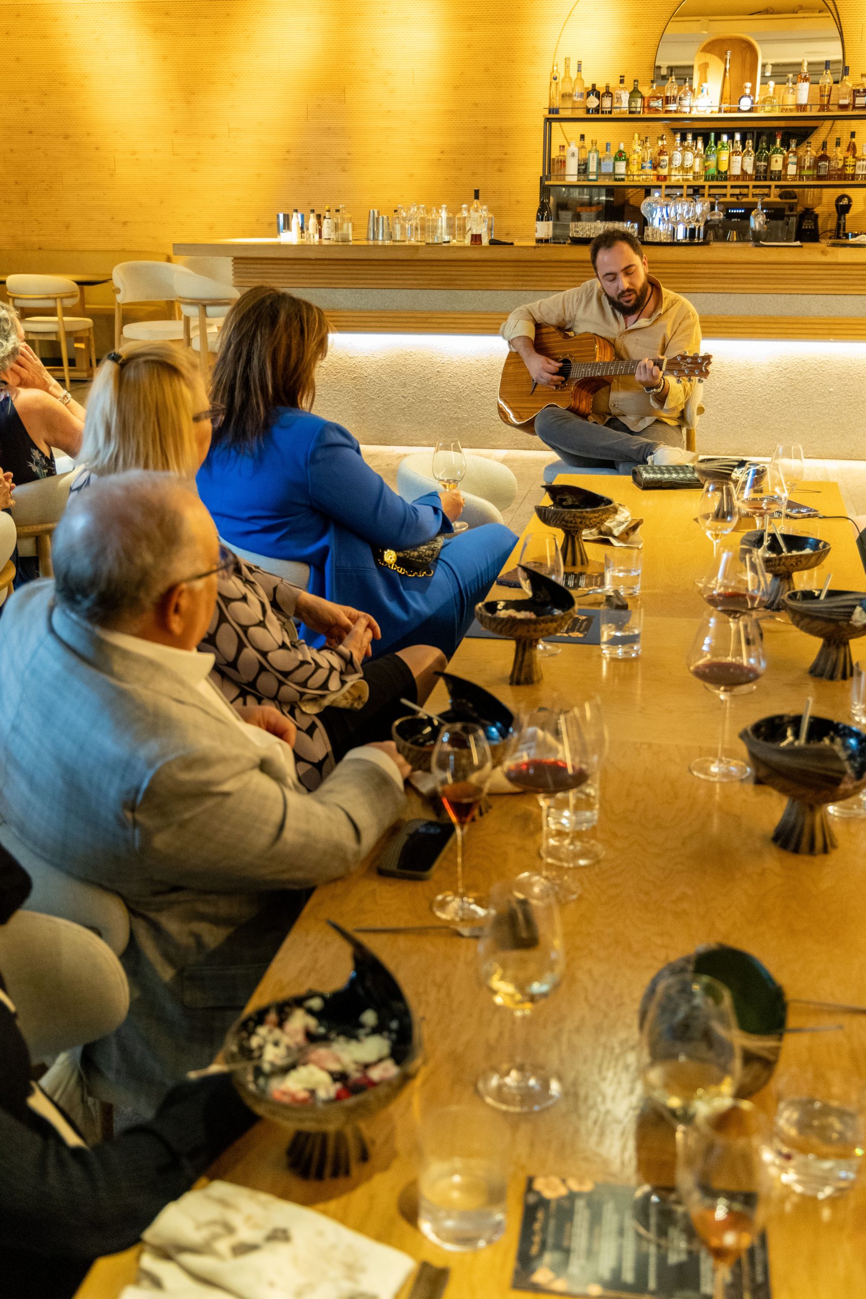 Private wine tasting experience with live music in an elegant bar setting in Greece