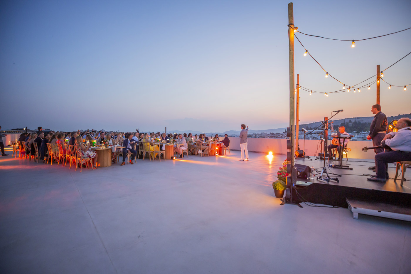 YPO Mayfair rooftop dinner in Athens – corporate event with live Greek music and sunset views, organized by DMC agency Feelosophy for luxury incentive trips in Greece.