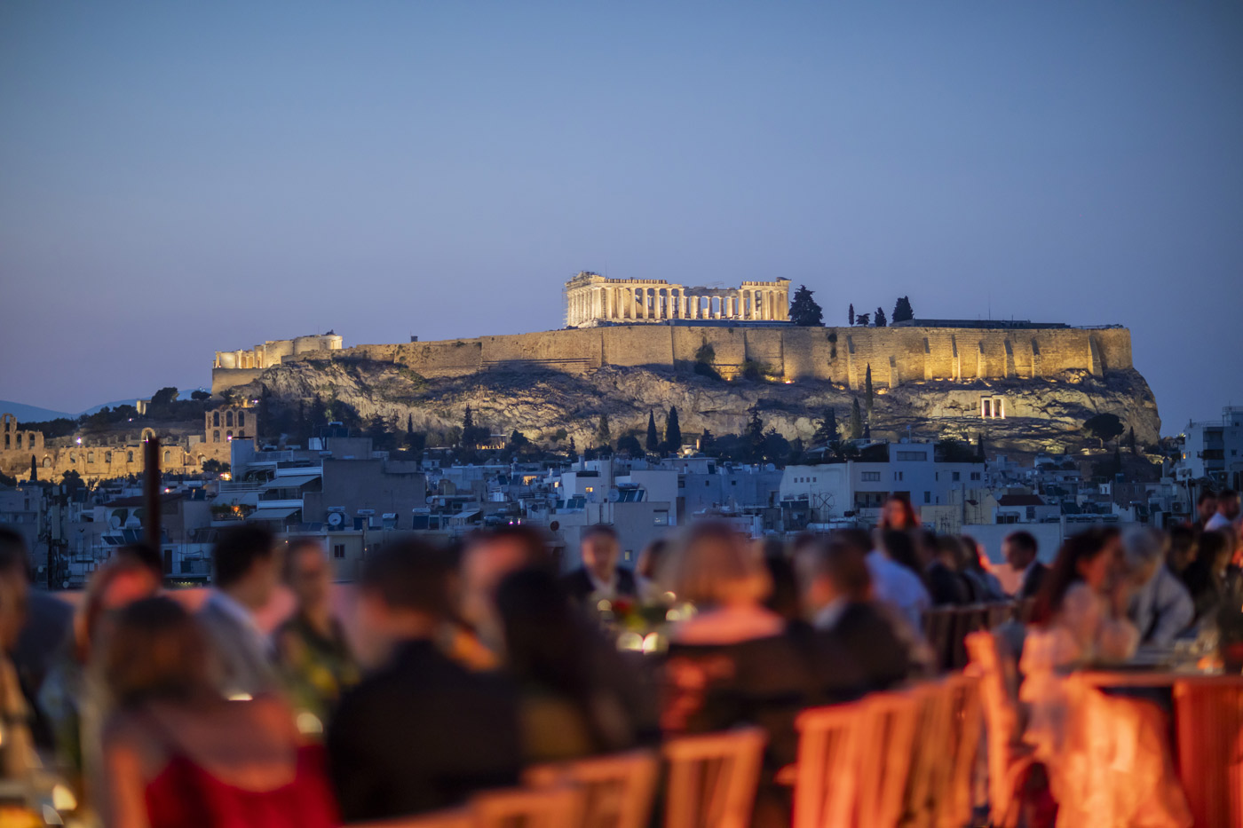 YPO Mayfair rooftop dinner in Athens – guests dining with stunning Acropolis view, curated by DMC agency Feelosophy for luxury corporate incentive events in Greece.
