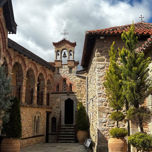 Stone monastery courtyard in Meteora, Greece, symbolizing reflection and stillness during a private generational leadership retreat.