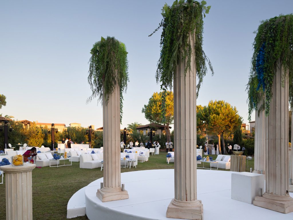 Elegant garden setup with classical columns for a private 40th birthday celebration in Costa Navarino, designed with refined Mediterranean style.