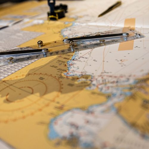 EO Regional Leadership Academy navigation planning session with maritime chart and tools on table